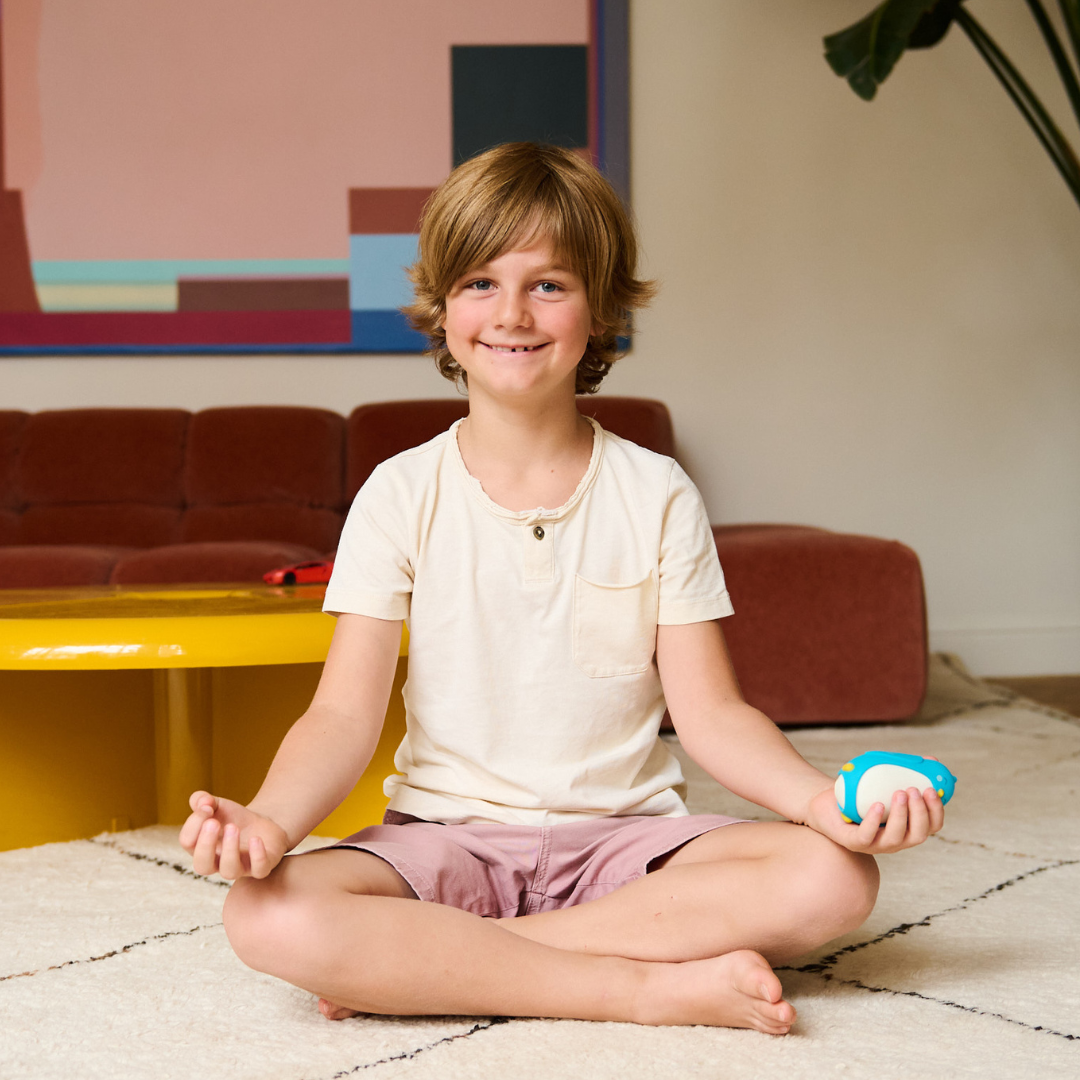 Young boy practicing self-regulation with moonbuddy